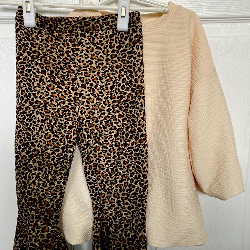 Like new condition bubble top in cream with leopard print flare stretch pants.